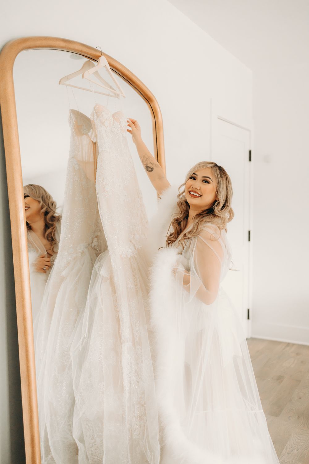 bride holding wedding dress