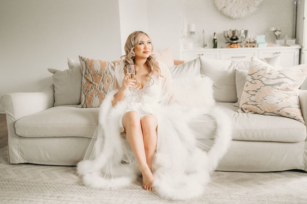 bride in bridal suite holding champagne glass