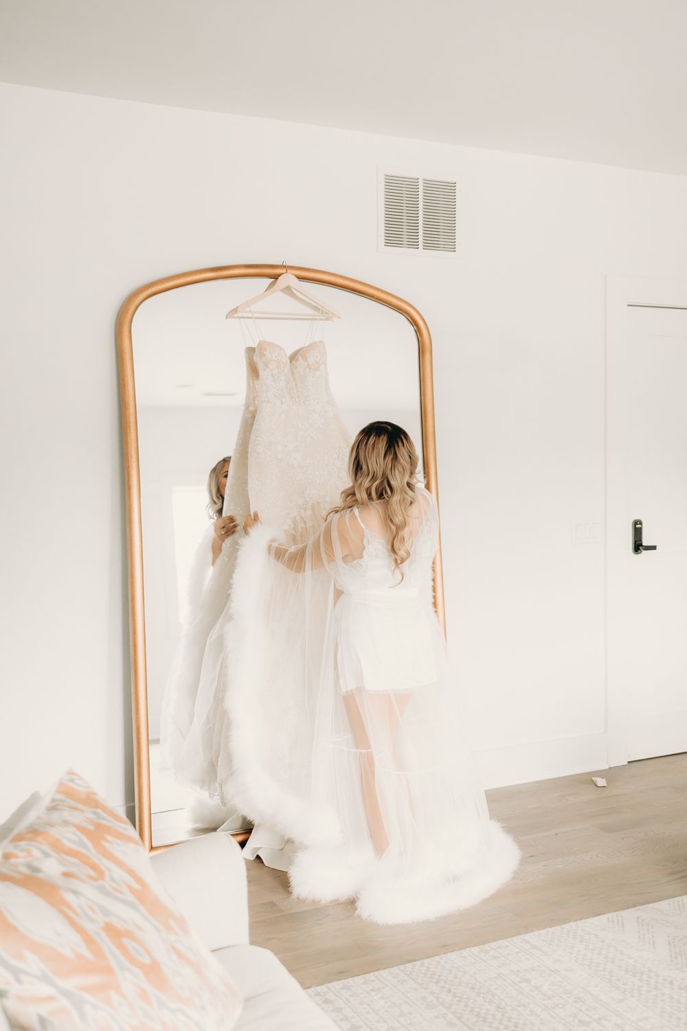 bride getting ready and looking at dress