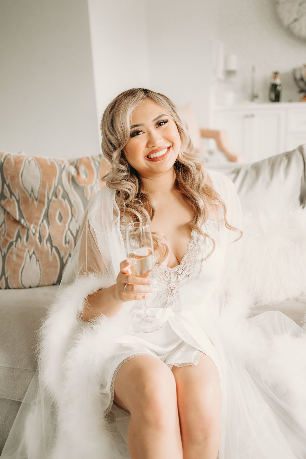 bride in bridal suite holding champagne glass
