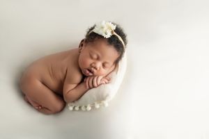 Detail shot of newborn's tiny feet and hands, showcasing the delicateness of early life.