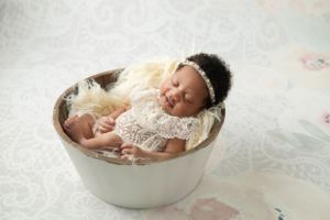Detail shot of newborn's tiny feet and hands, showcasing the delicateness of early life.