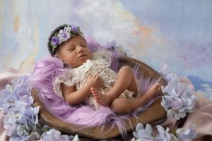 Detail shot of newborn's tiny feet and hands, showcasing the delicateness of early life.