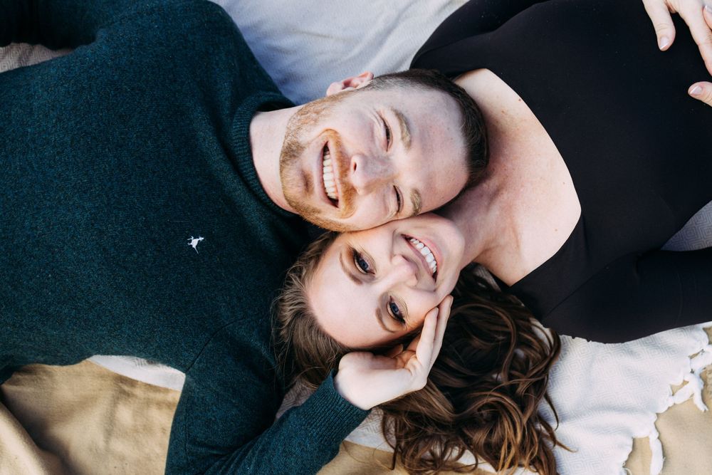 Laying down engagement photo looking at camera