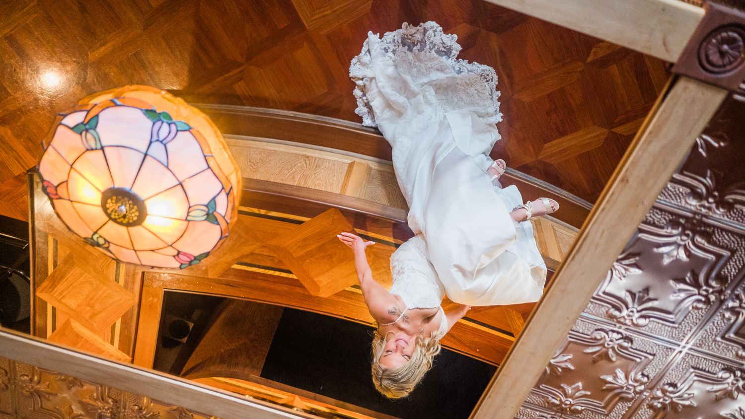 Reflection of the bride seated at the venue's bar.