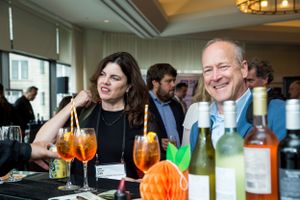 Business networking event with drinks and casual conversation among attendees.