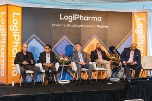 Panel discussion at LogiPharma conference with speakers seated on stage.