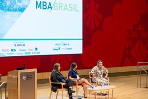 Business professionals participate in panel discussion at MBA Brasil conference.