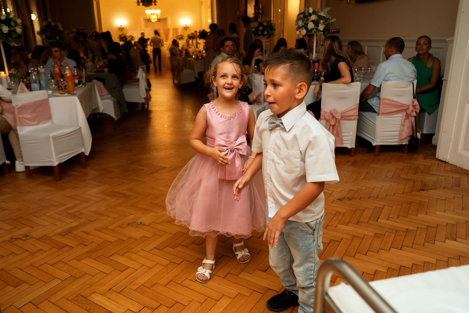 Wedding reception guests dancing together in elegant venue.