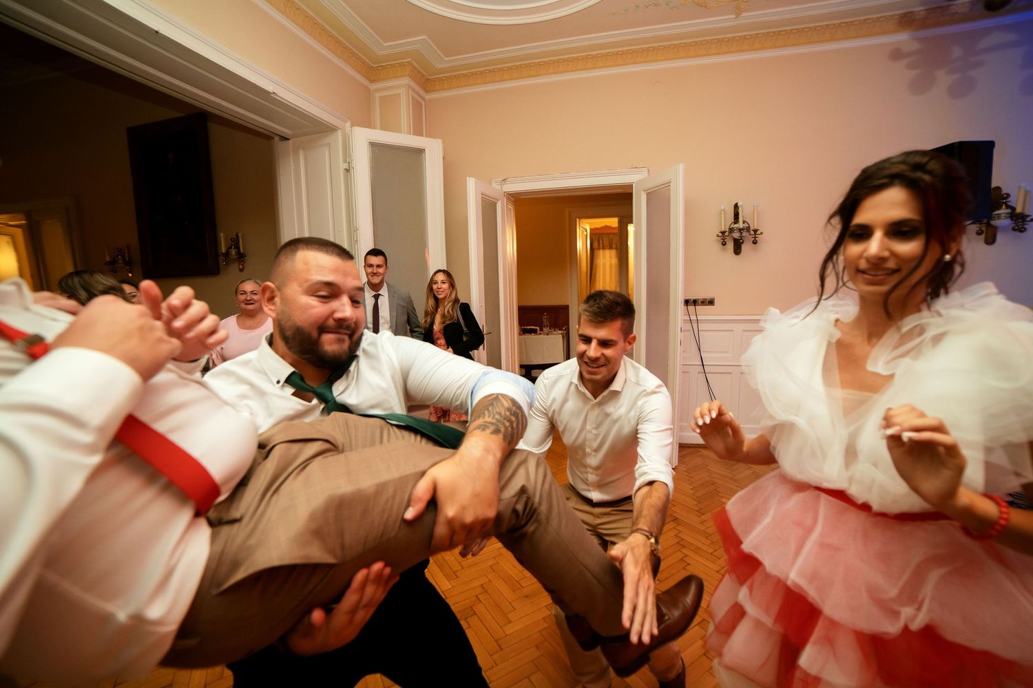 Energetic dancing and celebration taking place at an indoor party venue.