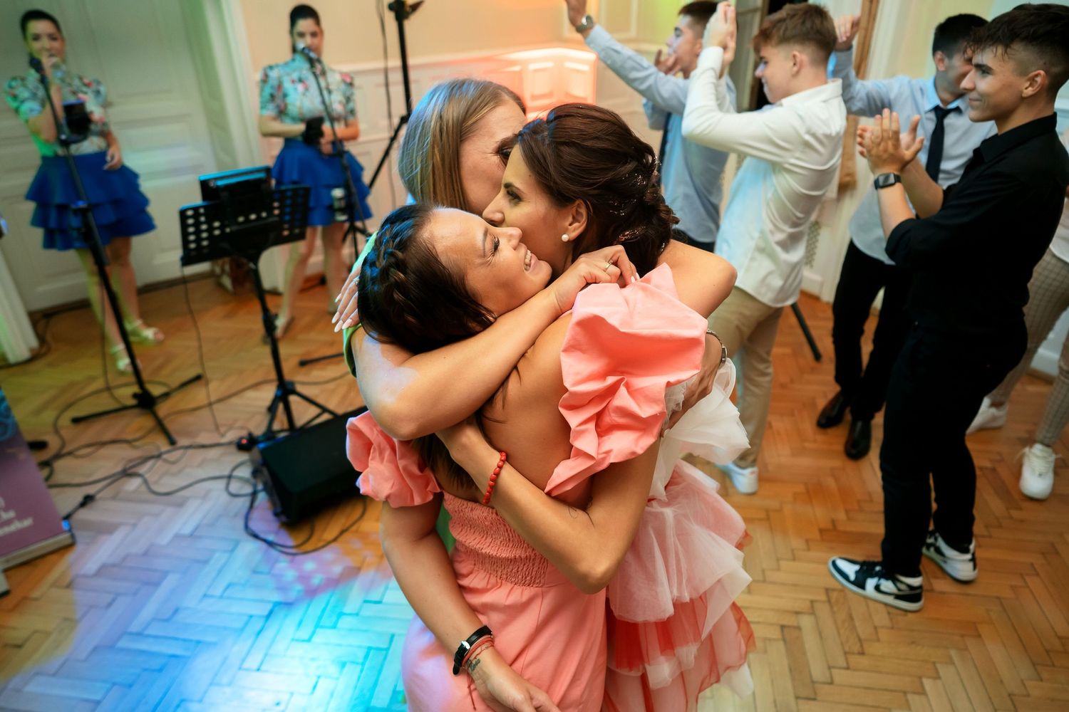 Dancing couple sharing an intimate moment at a reception with musicians visible in background.