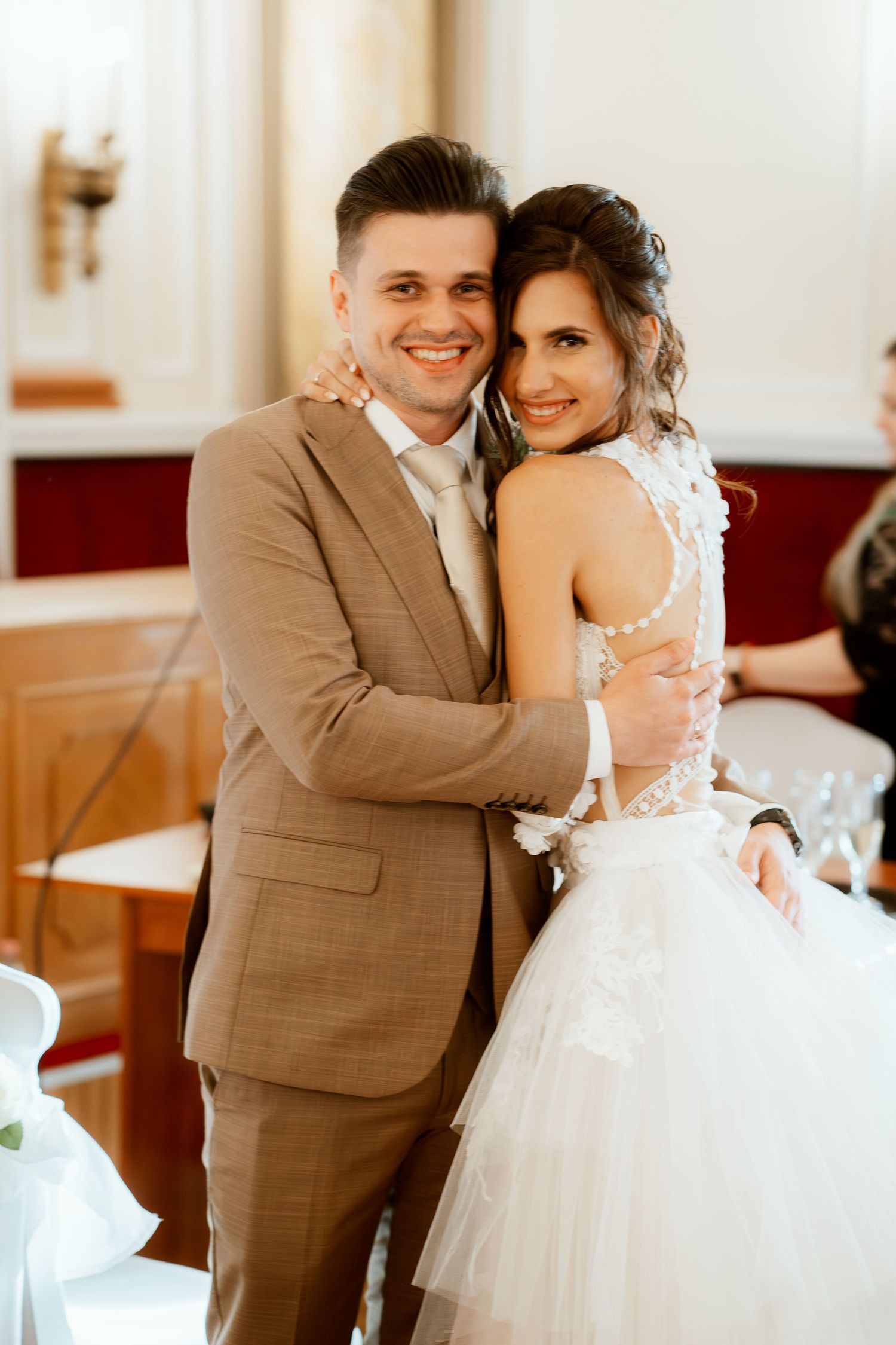 Romantic wedding portrait in an elegant venue interior.