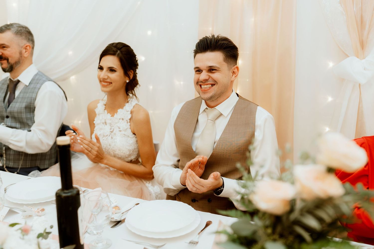 Wedding reception table setting with guests enjoying the celebration.