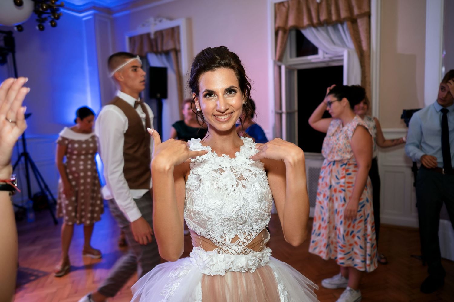 A stunning reception hall with pink and blue lighting sets the mood for celebration.