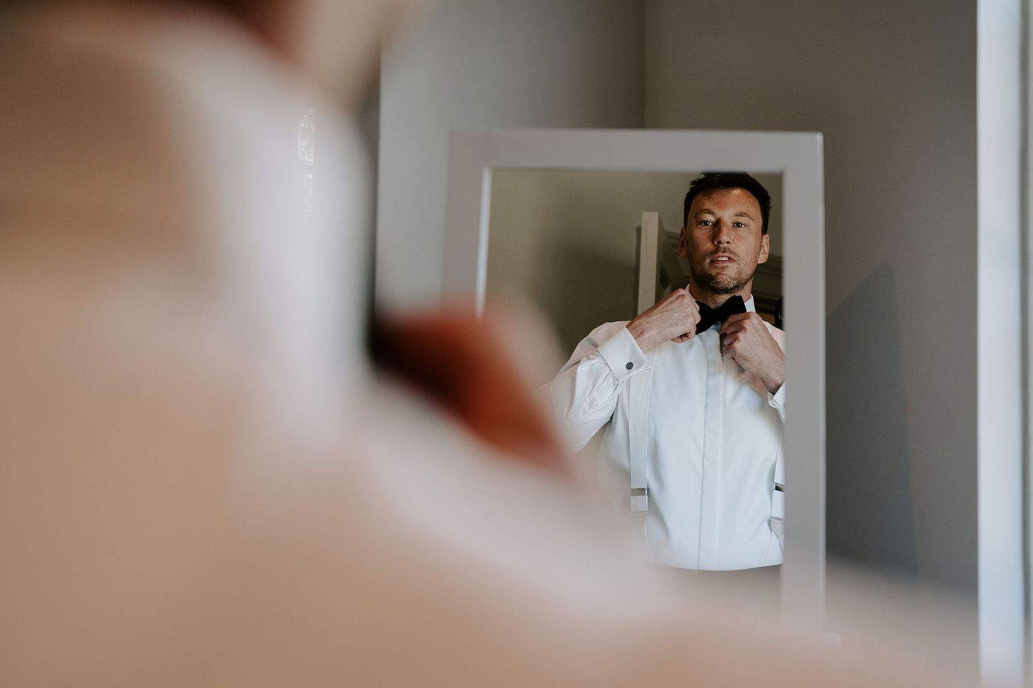 groom-tying-bowtie-stockton-house-wedding-shropshire