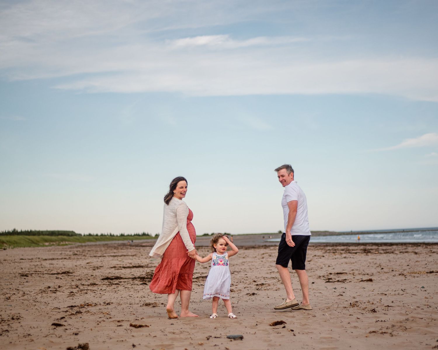 Family walking on Conrad's Beach in Lawerencetown, Nova Scotia