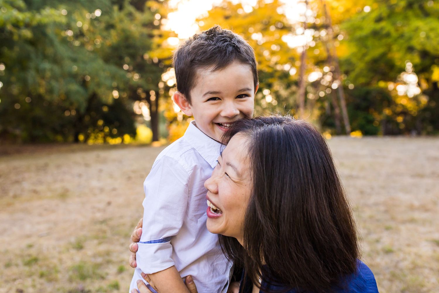 Mother and son having a laugh together at sunset