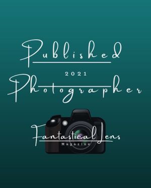 Fantastical Lens Magazine 2021 Published Photographer badge on teal background with camera graphic.