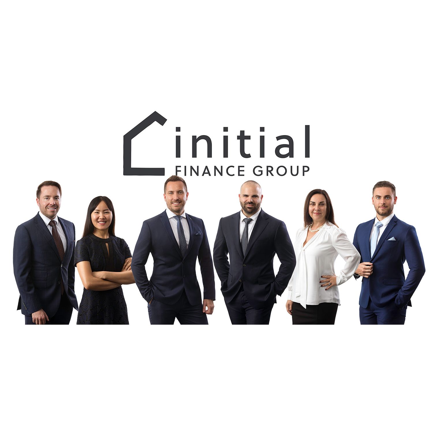 Professional business team members in suits standing against white background.