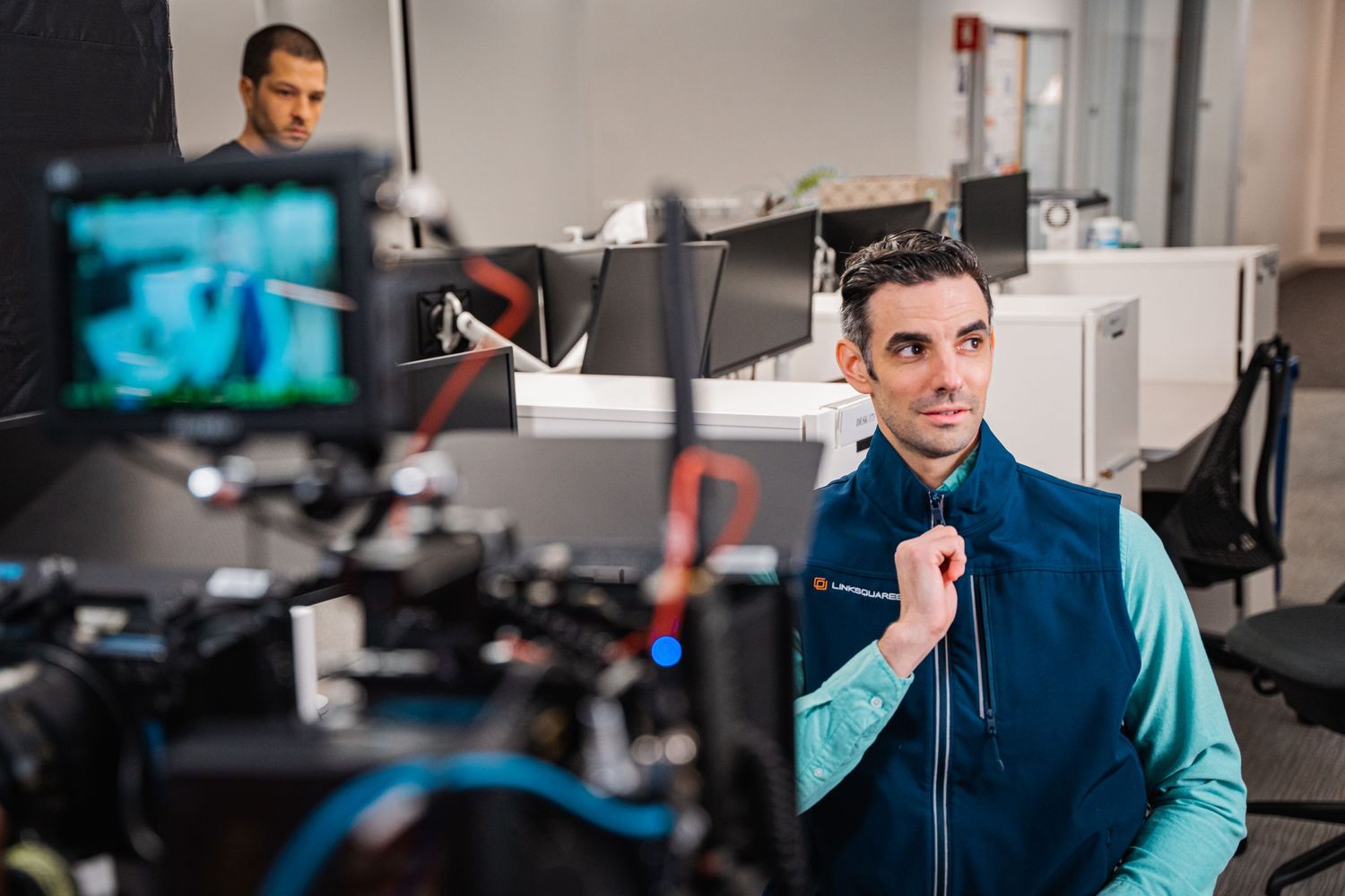 Television presenter or host speaking to camera in professional broadcast studio.