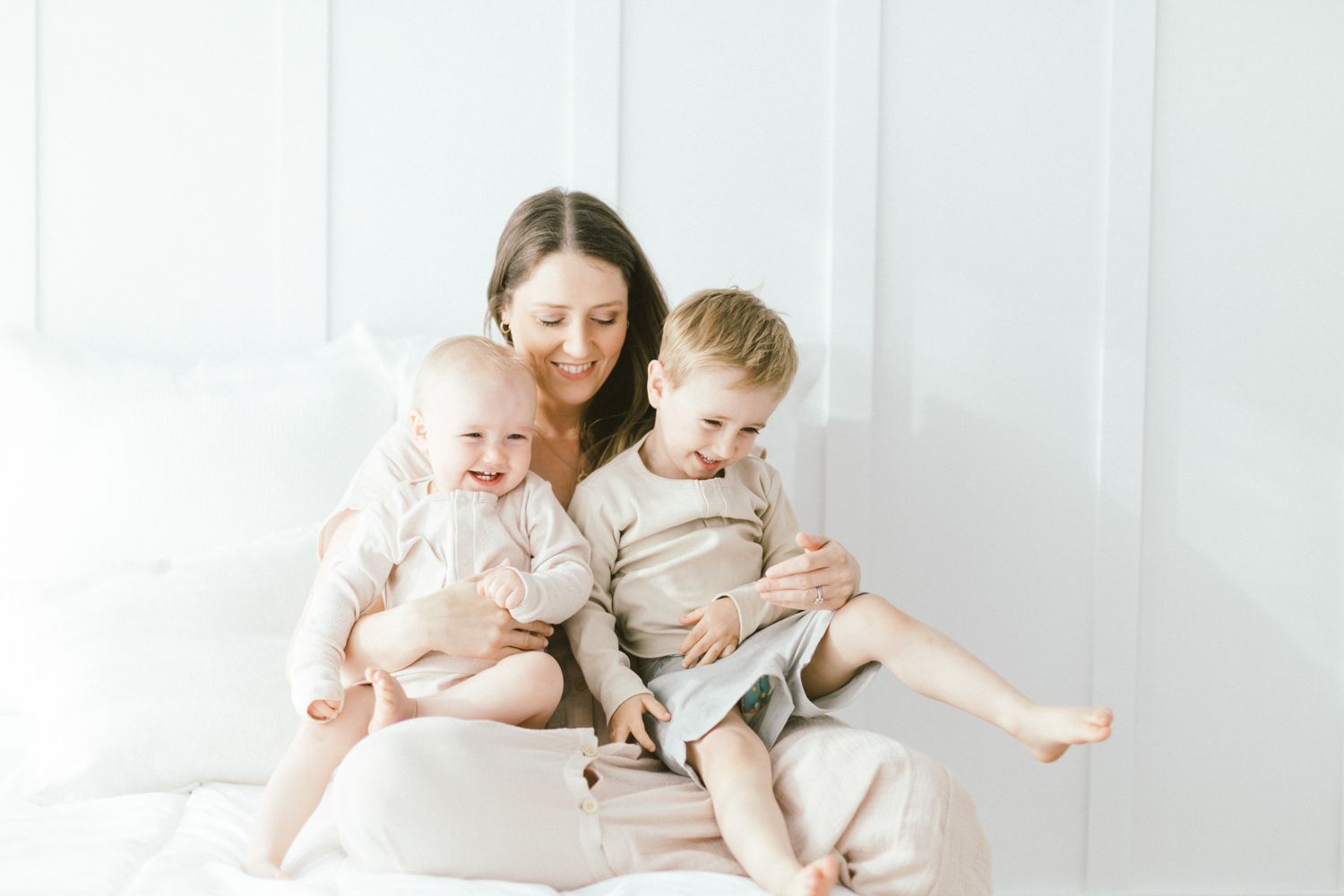 Tender family moment captured in bright, minimalist setting.
