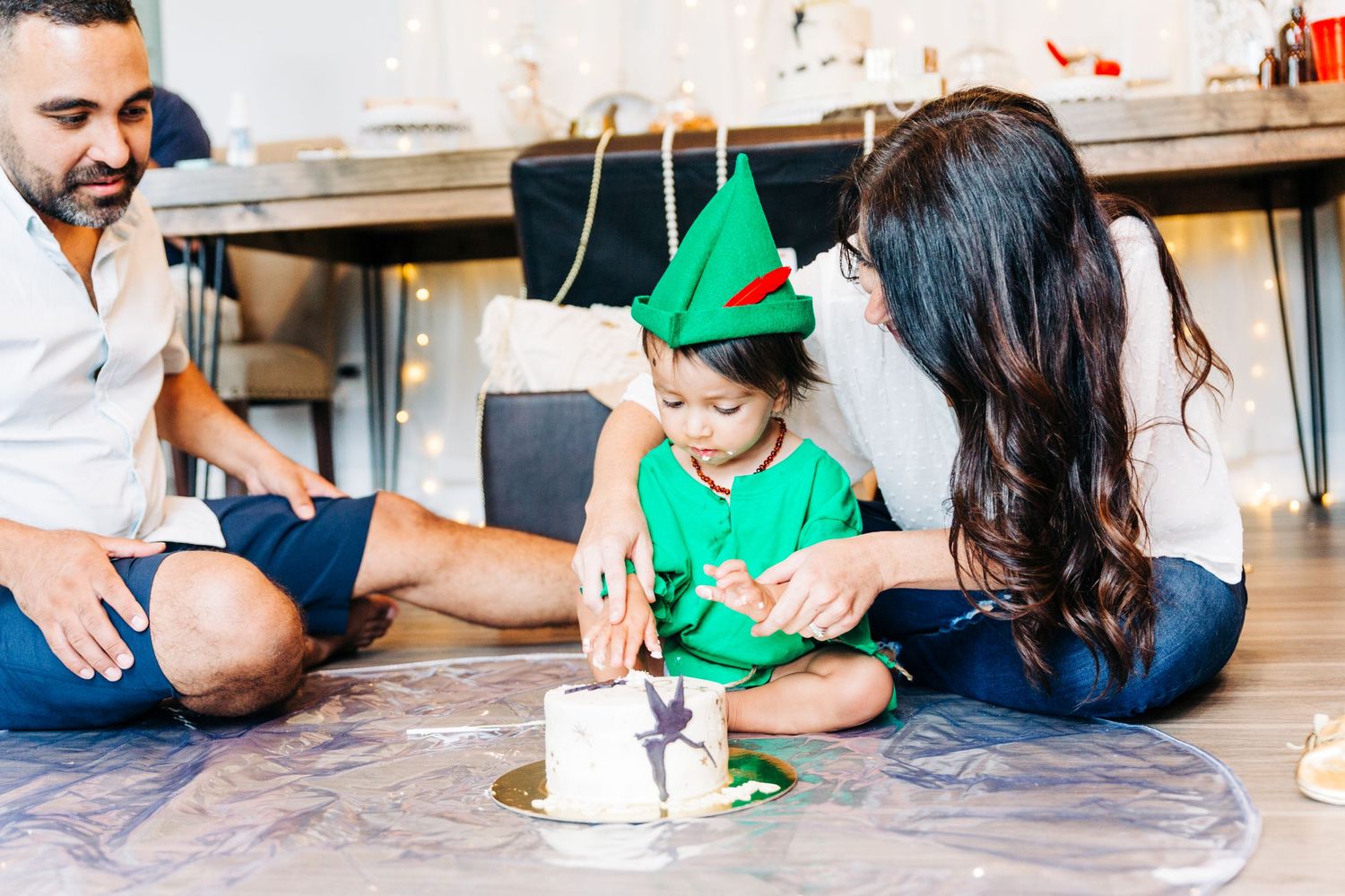A one year old boy unsure about eating a cake