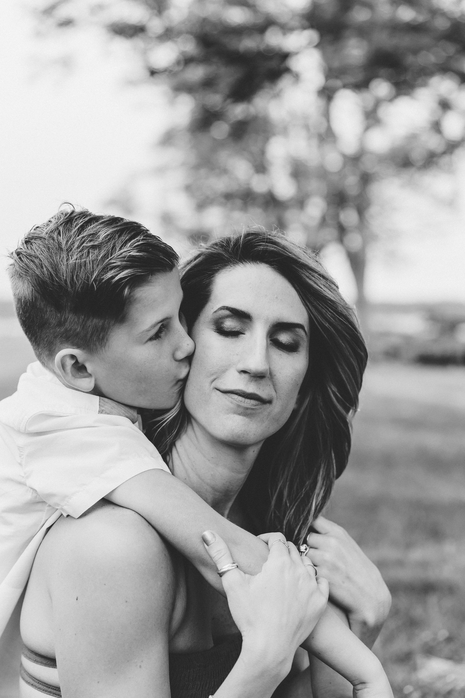 Touching photo of a young boy kissing mom's cheek