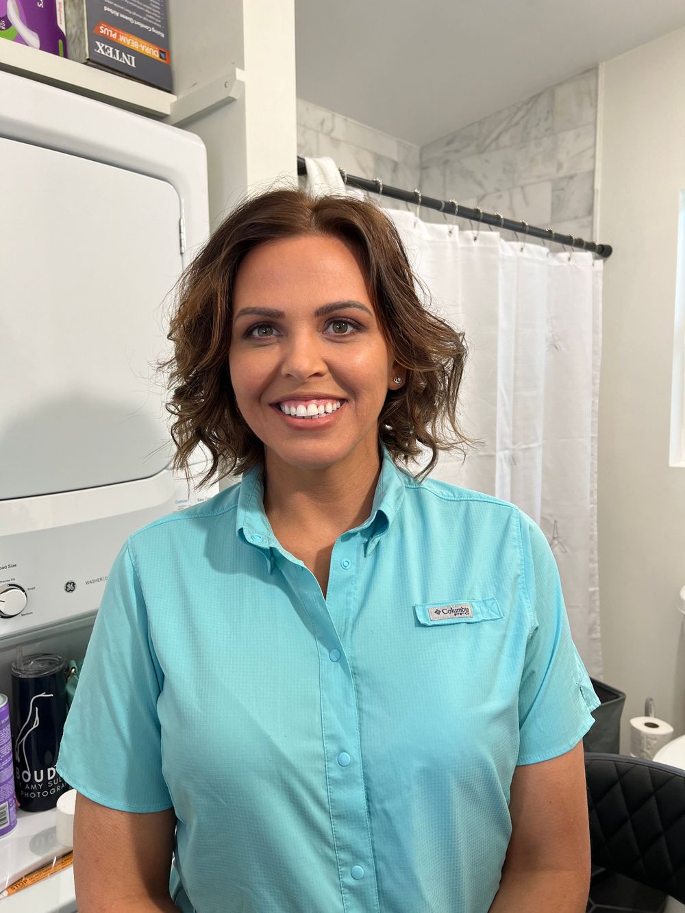 Medical professional in turquoise scrubs posing for photos.