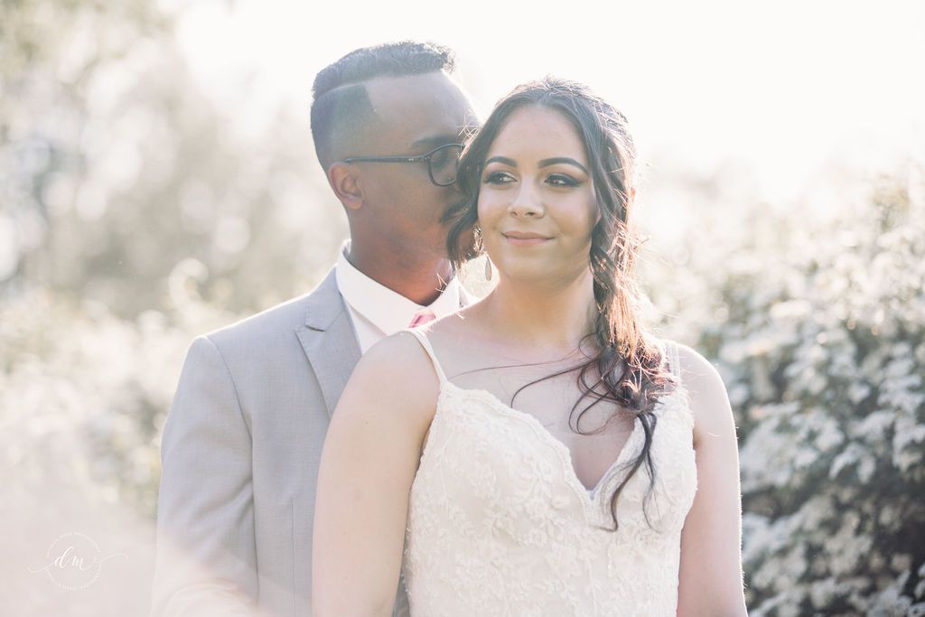Romantic soft-focus portrait of couple in wedding attire.