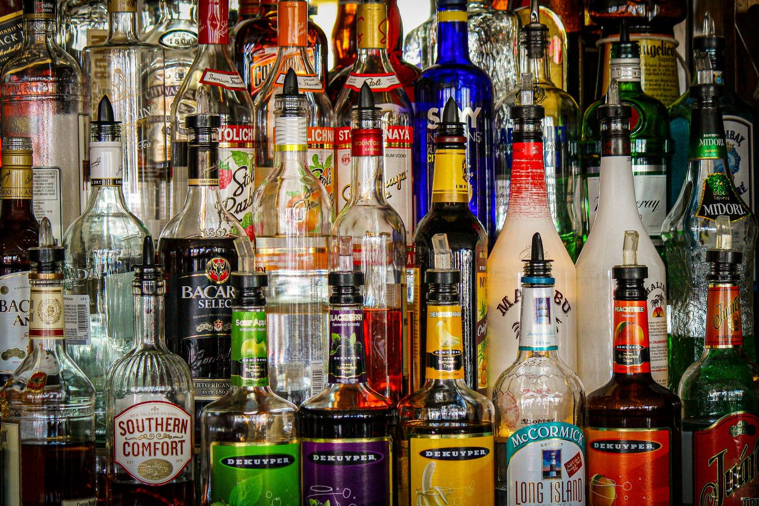 Picture of random bottles of Alcohol behind an Outdoor Bar