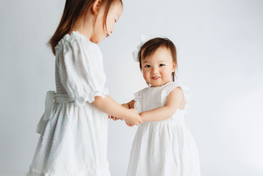 Asian sisters playing ring-around-the-rosie. Greenville, SC newborn photographer, Easley, SC Newborn photographer