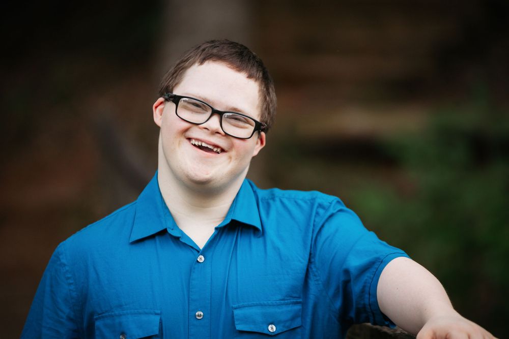 Down syndrome senior session and he is smiling at the camera. Greenville, SC newborn photographer, Easley, SC Newborn photographer