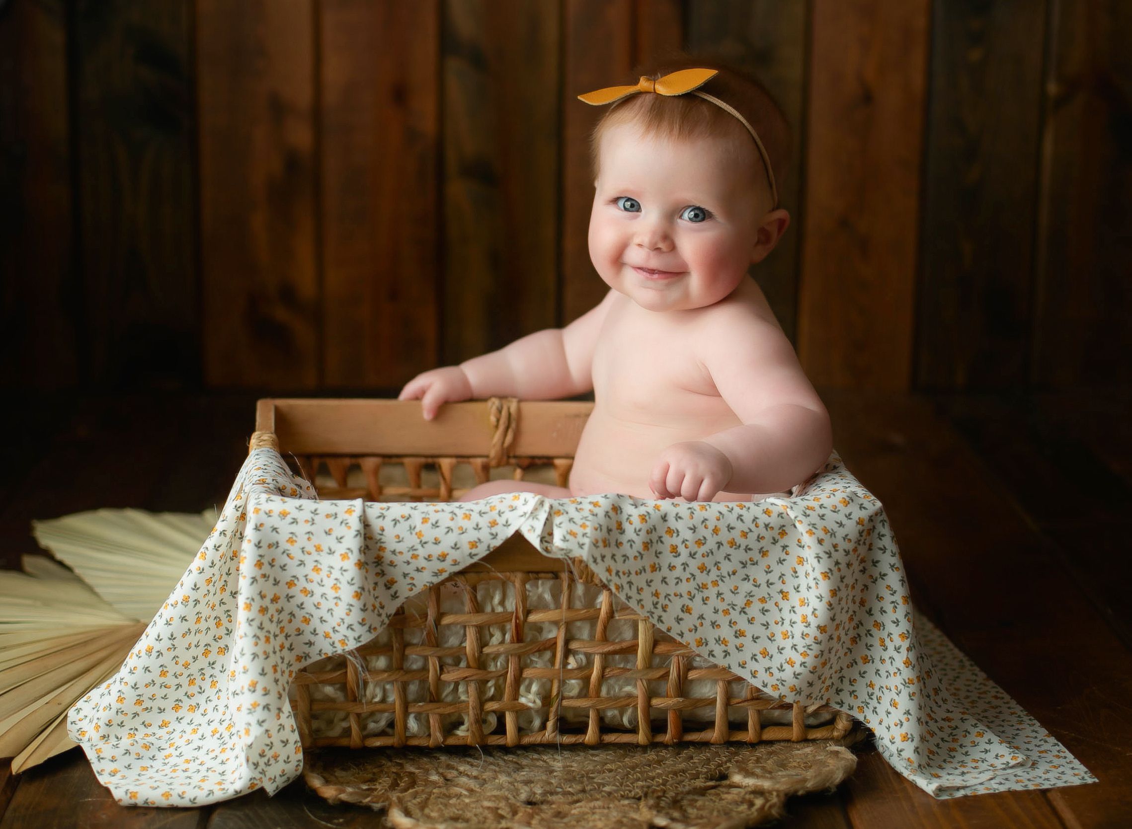 Milestone session with girl in a basket grinning. Greenville, SC newborn photographer, Easley, SC Newborn photographer