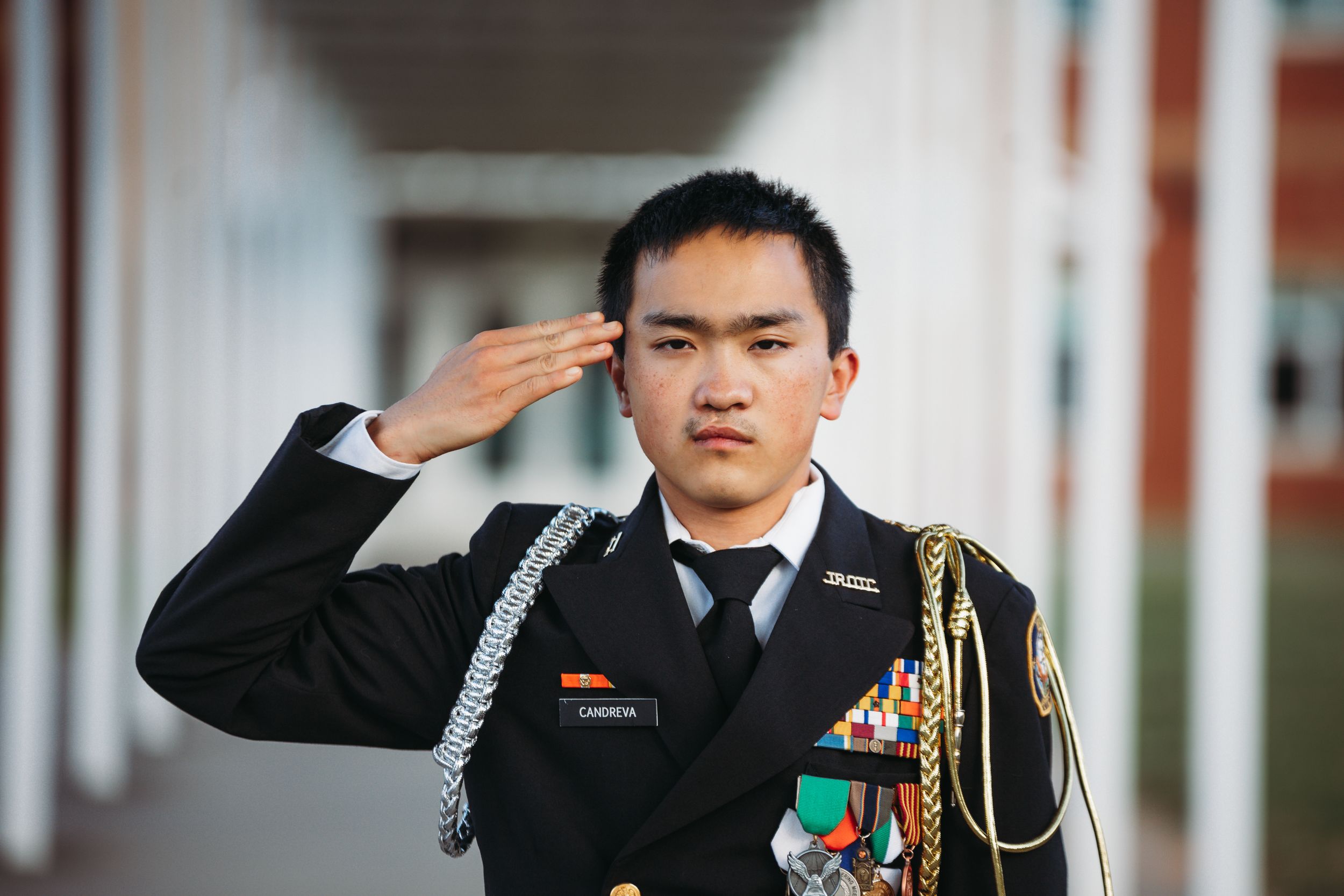 Asian young man saluting the camera wearing his ROTC uniform. Greenville, SC newborn photographer, Easley, SC Newborn photographer
