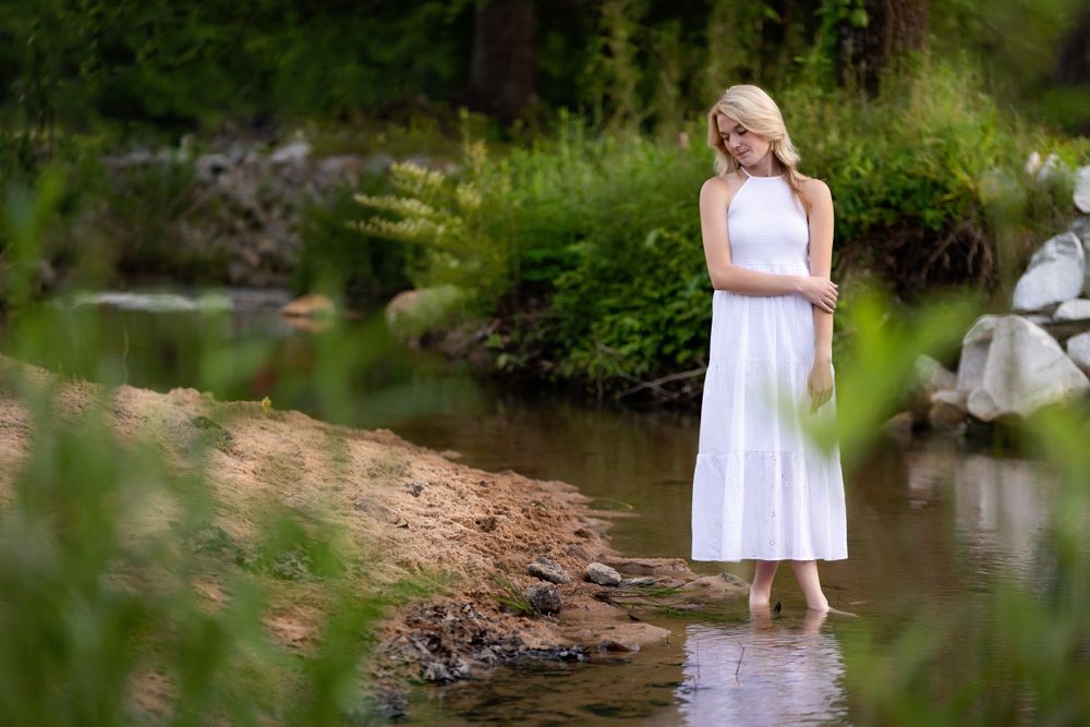 A Senior session with a lady standing by the water. Greenville, SC newborn photographer, Easley, SC Newborn photographer