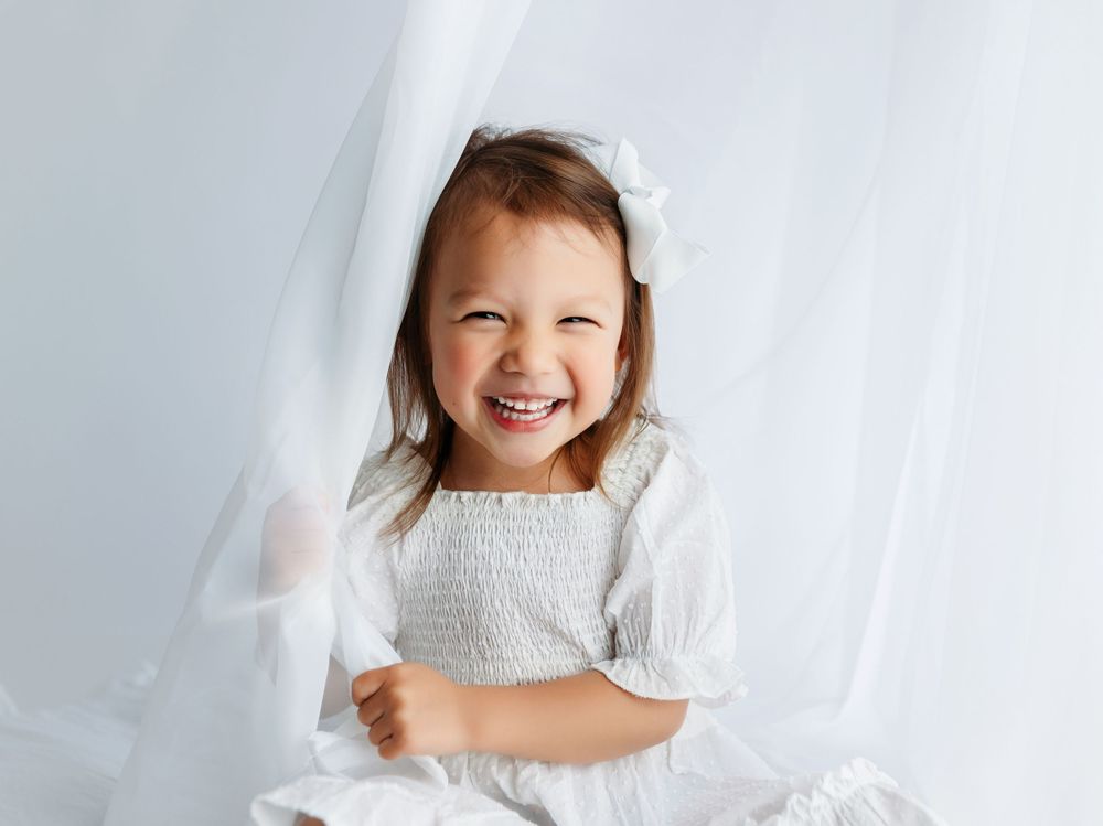 Toddler playing peek a boo with a sheer white curtain. Greenville, SC newborn photographer, Easley, SC Newborn photographer