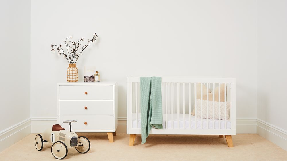 Baby Crib and Drawers inside a nursery room