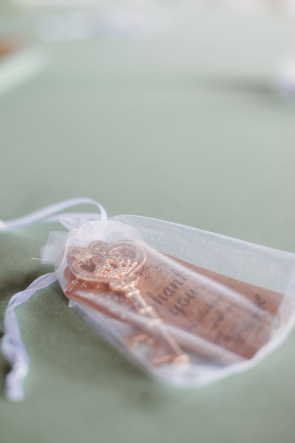 Close up of a delicate organza favor bag with vintage style tag.