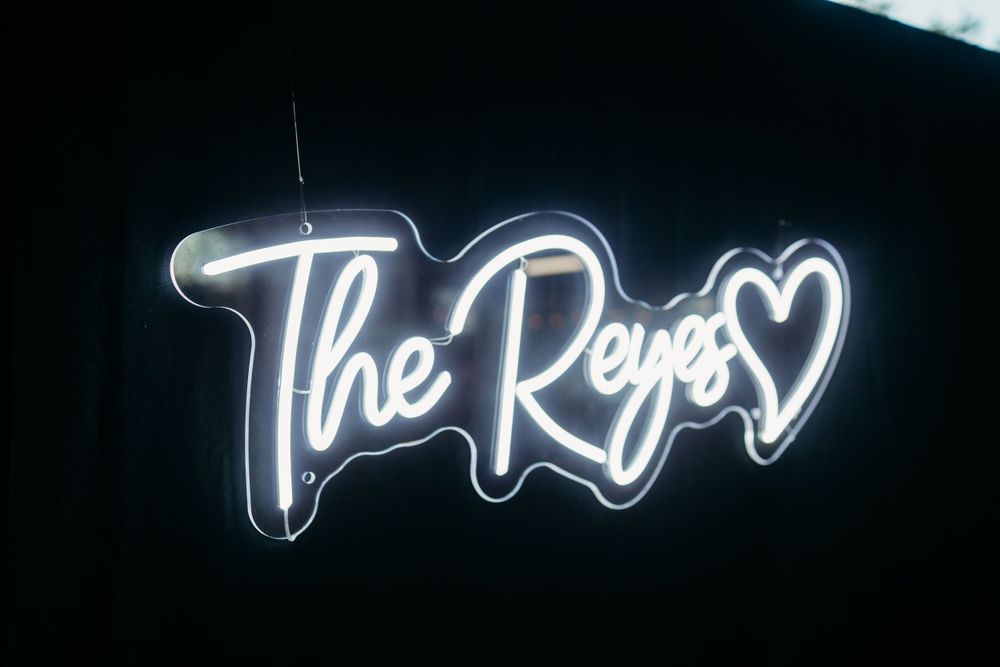 The Reps illuminated neon sign glowing against a dark background with a heart symbol.