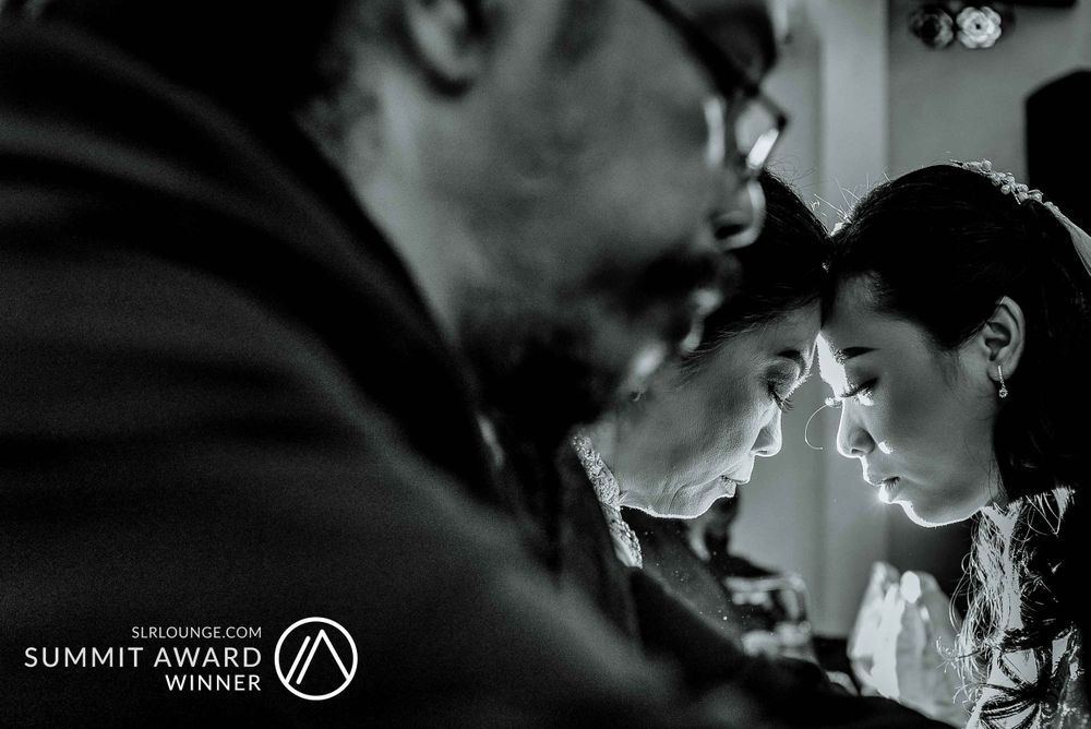 Atmospheric black and white portrait of couple in dramatic lighting.