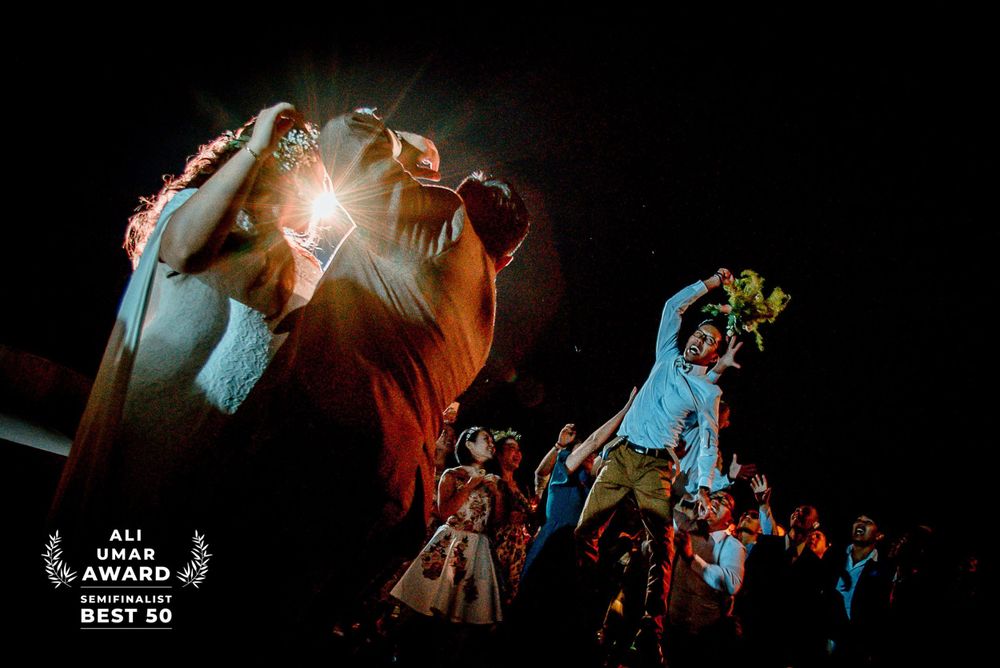 Colorful night performance with dramatic lighting and costumed figures on stage.