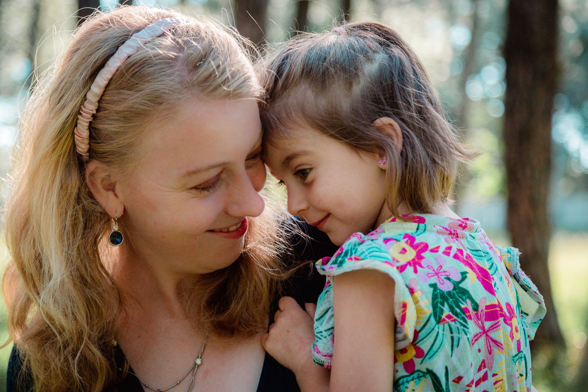 Intimate, loving moment between a mother and her young daughter