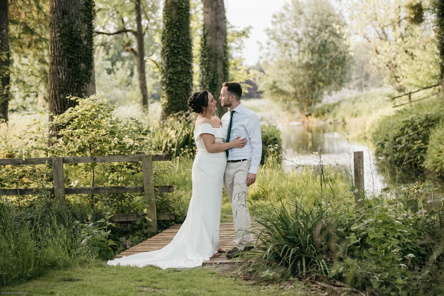 A romantic moment between newlyweds in a lush garden setting.
