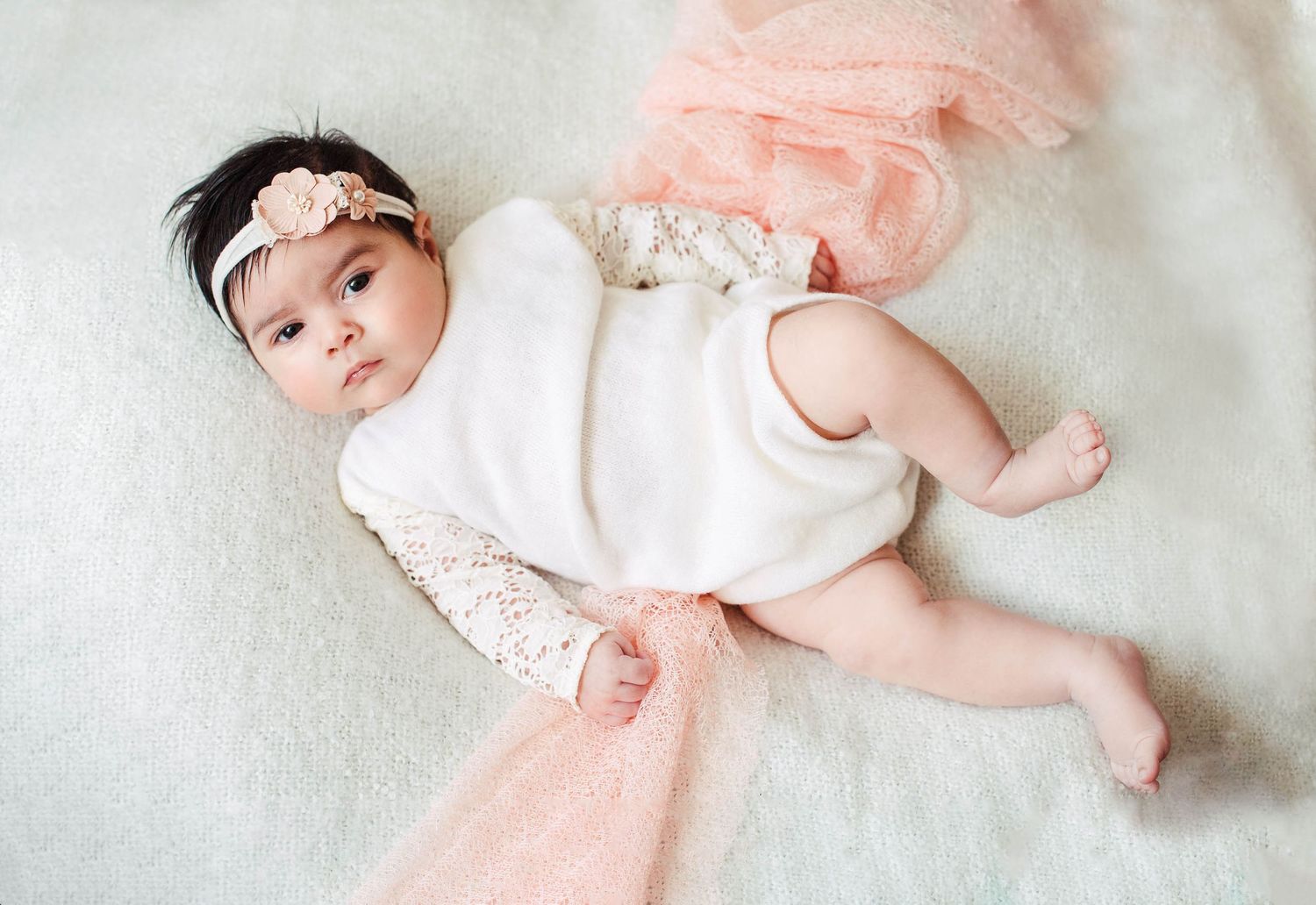 beautiful little baby girl on a white blanket. London newborn photography