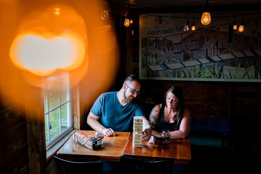 Warm amber-lit interior of a restaurant or bar with hanging pendant lights.