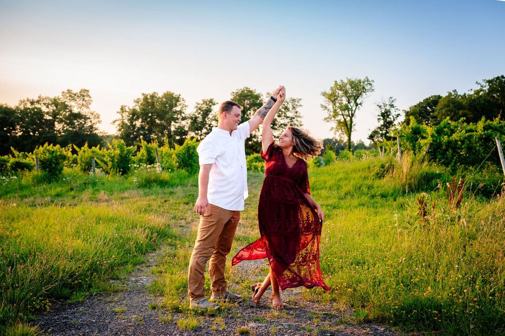 Couple walking through a sunlit meadow on a summer evening.