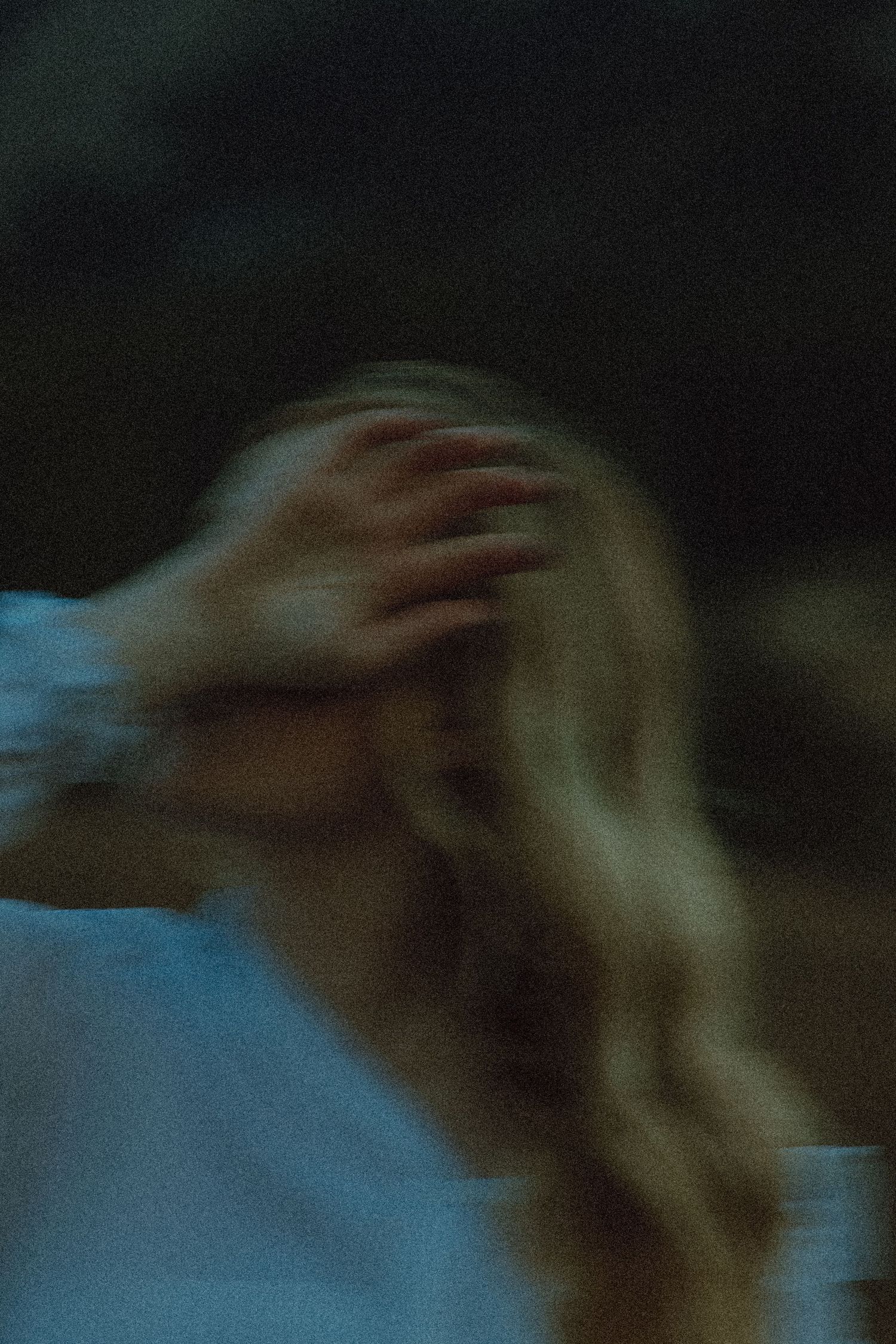 Blurry image of girl with her hand over her face