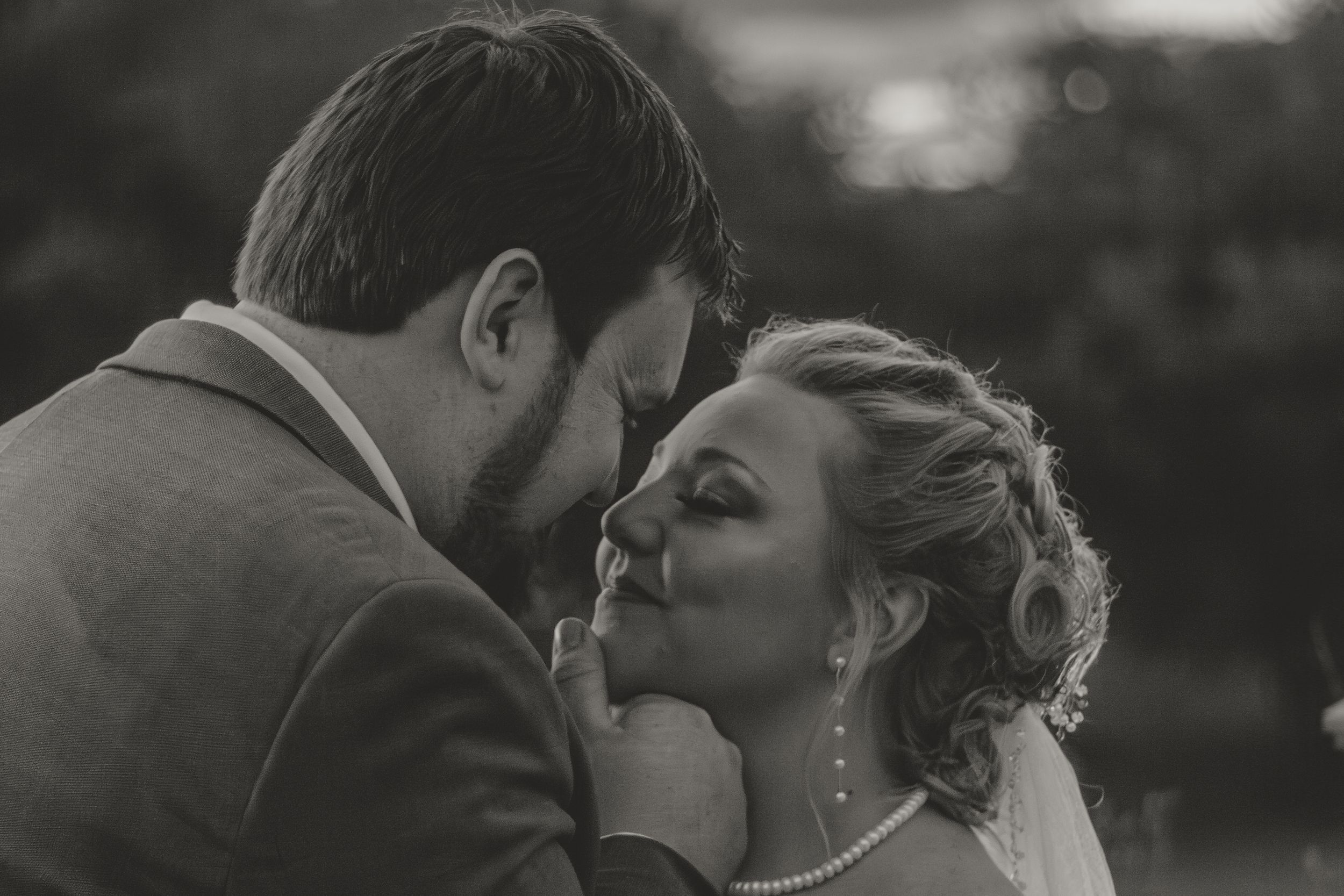 Black and white wedding portrait series showing intimate moments between newlyweds.