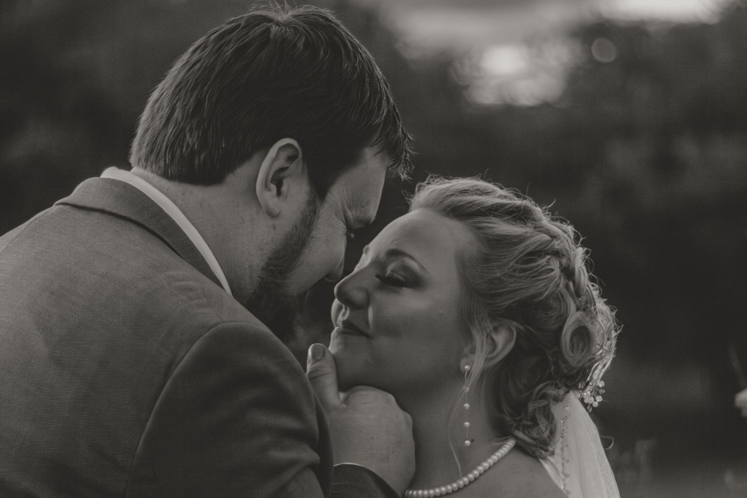 Black and white wedding portrait series showing intimate moments between newlyweds.