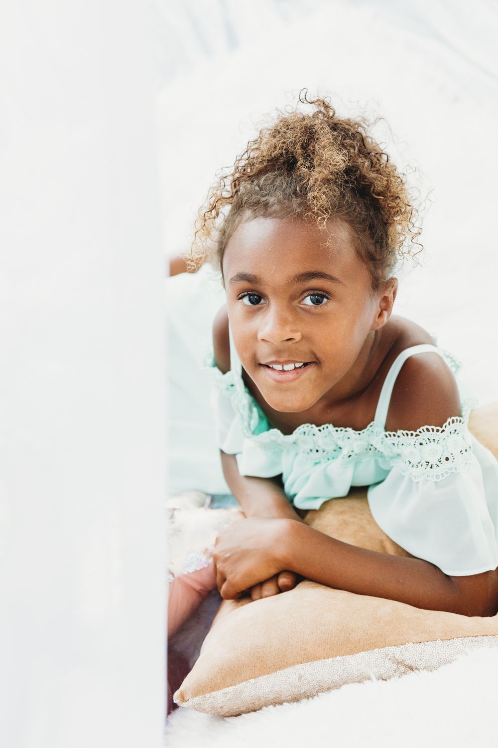 Soft portrait photography against white background with natural lighting.